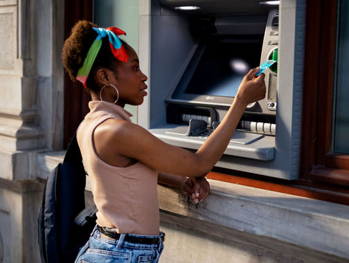 women usign ATM machine