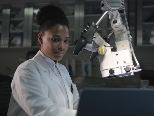 lady working with microscope