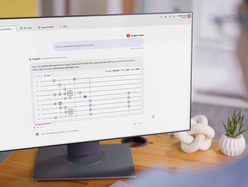 A monitor displays a Chemistry report from Microsoft Quantum suite